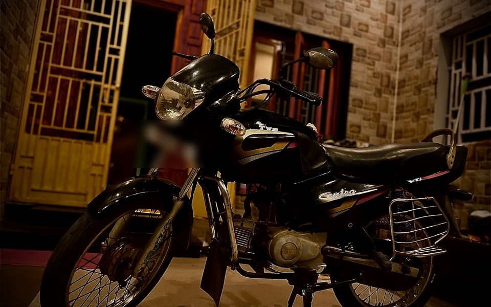 The restored TVS Centra motorcycle at night